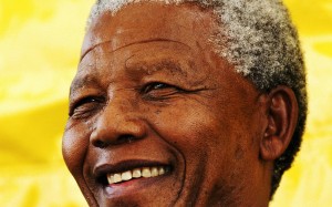 Image of Nelson Mandela's face smiling against a yellow background. Licence: Attribution-NonCommercial-NoDerivs 2.0 Generic. Source: https://secure.flickr.com/photos/presidenciard/